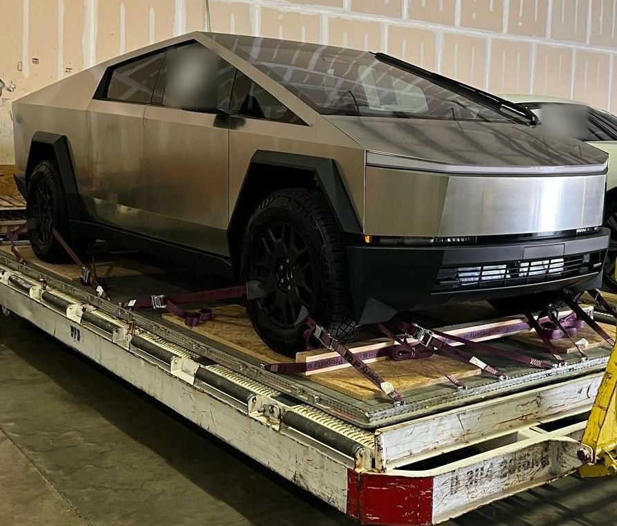 A Tesla Cybertruck strapped down on a transport flatbed